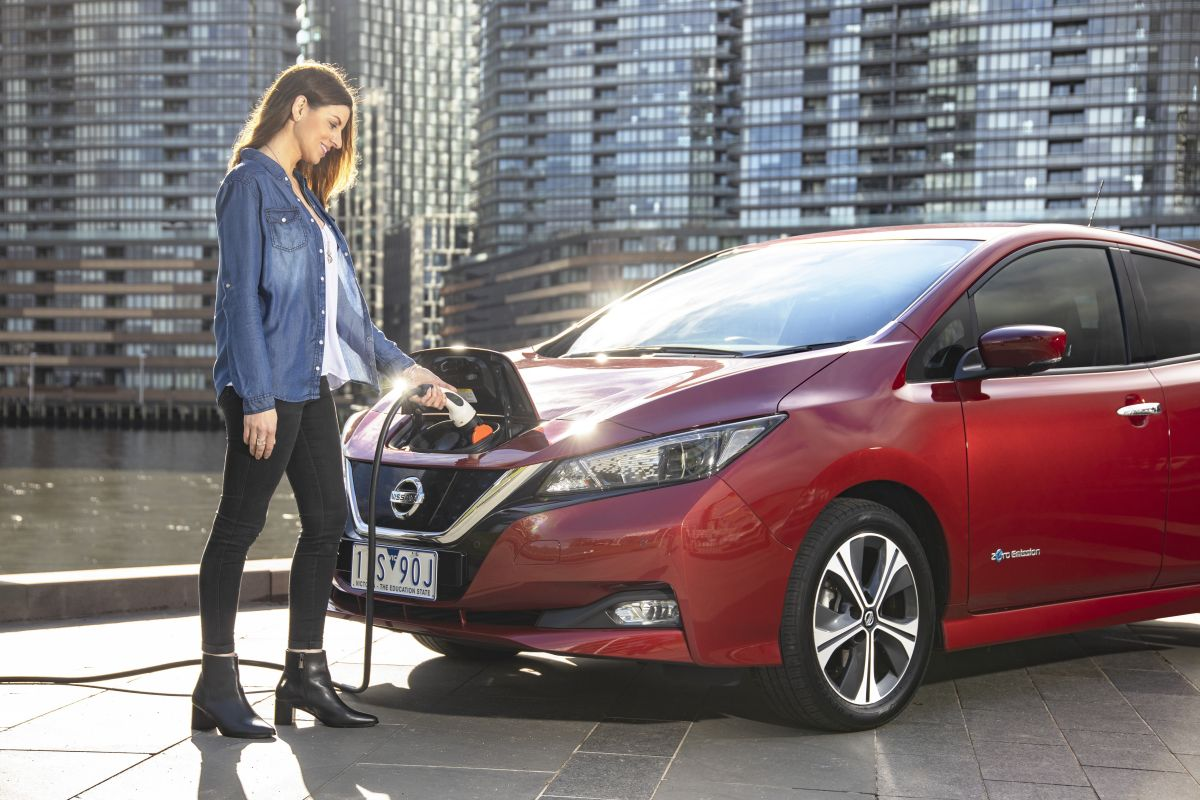 person charging electric vehicle 