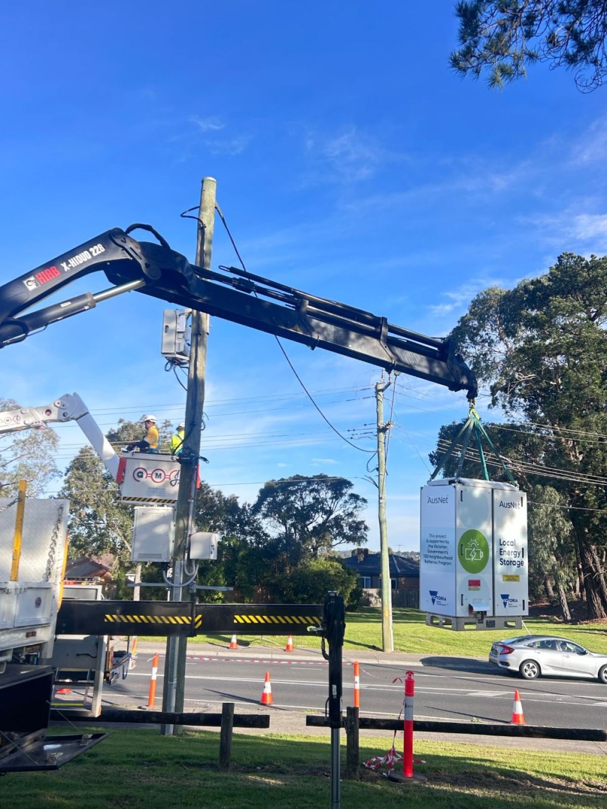 Battery being hoisted on crane for installation.