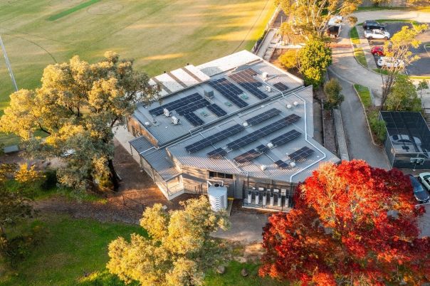 Drone picture of the Hurstbridge football pavilion showing its solar array and battery.