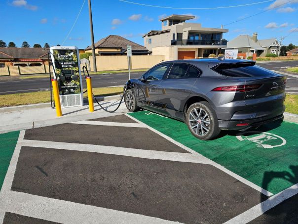 Photo of an electric vehicle parked at a charging station
