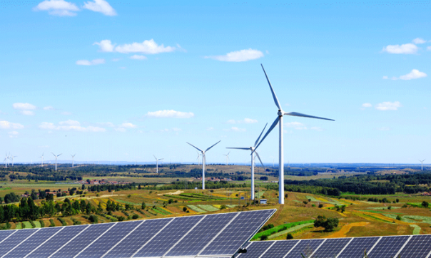 Solar panels and wind turbines in a field