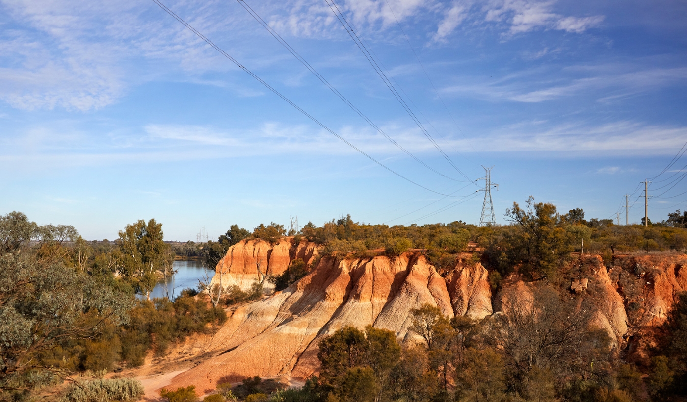 Red cliffs with transmission powerlines overhead